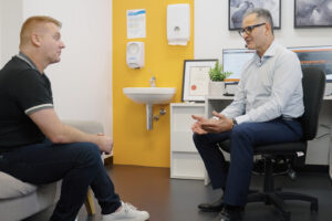 Chris Lekich and patient in consultation room